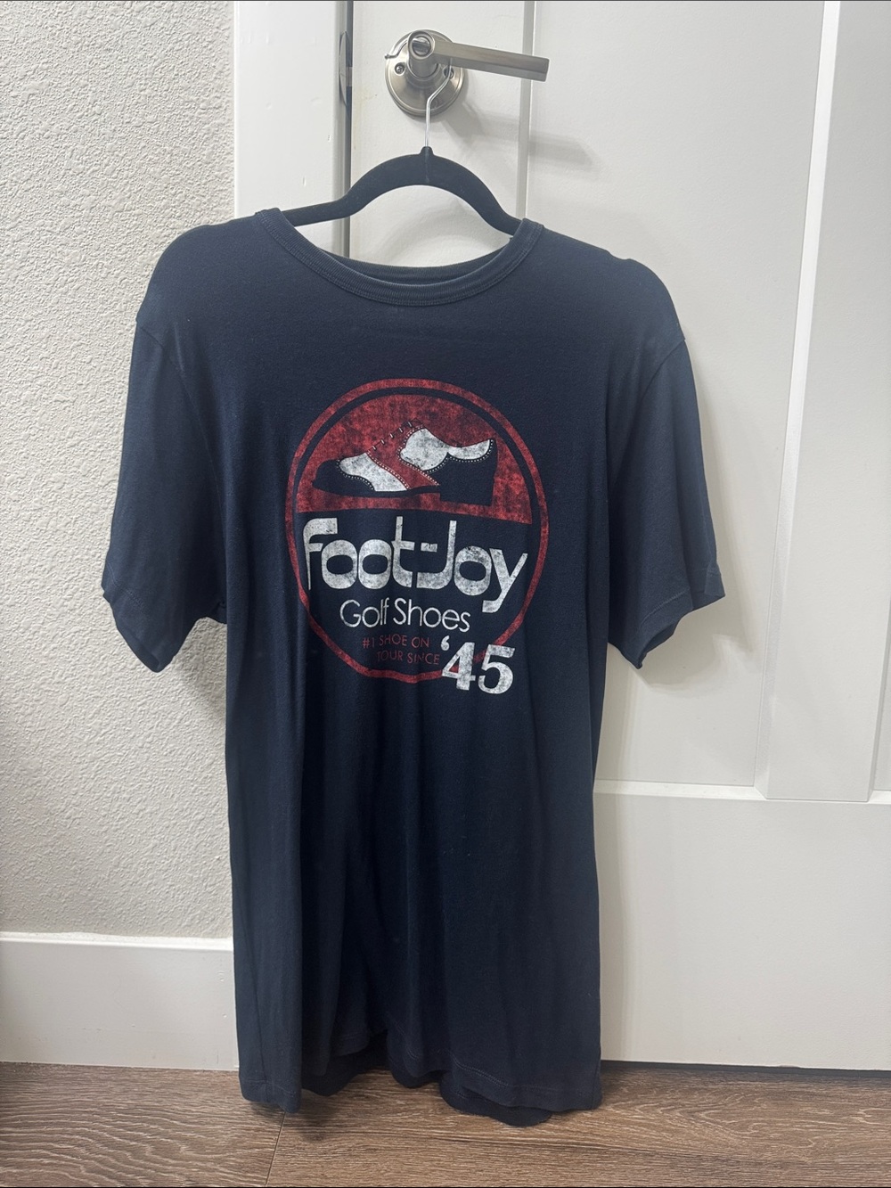 FootJoy Black Short Sleeve Graphic Golf Tee with Red and White Logo